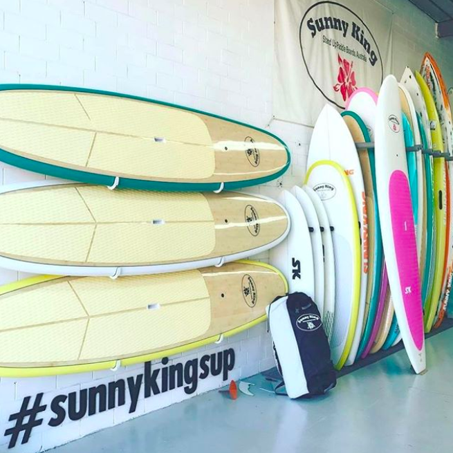 Sunny king sup isup by the sea with three family travel paddleboarding watersports